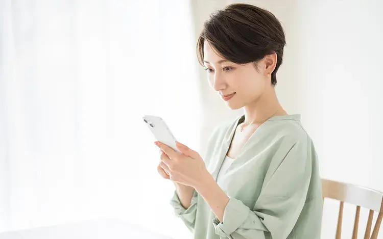 スマートフォンで質問する女性